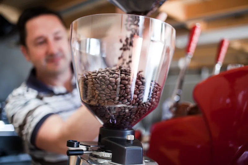 Chris at Talk Coffee, loading beans into the grinder